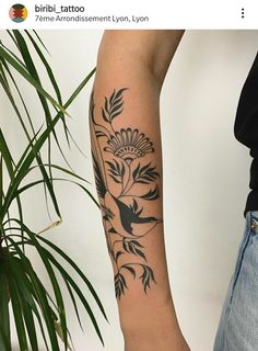 a woman's arm with a flower tattoo on it