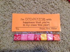 a candy bar with an orange tag that says, i'm wishing with happiness that you're in my class this year