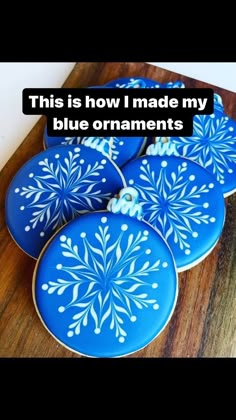 blue decorated cookies with white snowflakes are on a cutting board and the words, this is how i made my blue ornaments