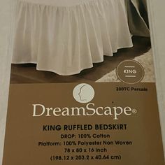 a bed with a white ruffled bedskirt on it's side and a brown sign that says dreamscape king ruffled bedskirt