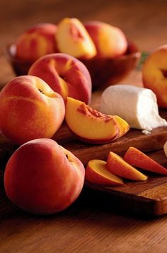 peaches, cheese and other fruits on a cutting board