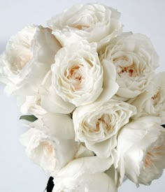 a bouquet of white flowers sitting on top of a table