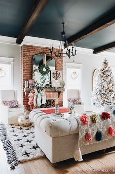 the living room is decorated for christmas with white furniture and colorful pom - poms