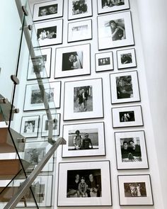 a staircase with many pictures on the wall