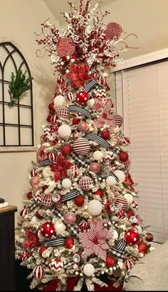 a christmas tree decorated with red, white and silver ornaments