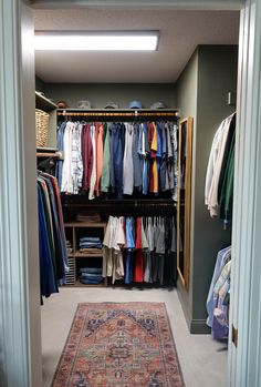 the closet is full of clothes and rugs