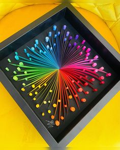 a colorful display in a black box on a yellow chair