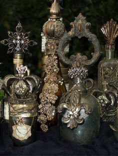 an assortment of decorative vases sitting on top of a black cloth covered tablecloth