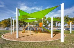 an outdoor play area with swings and slides