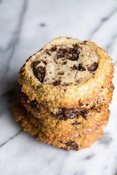 two cookies are stacked on top of each other, with chocolate chips in the middle