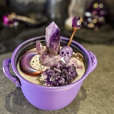 a purple pot filled with rocks and crystals