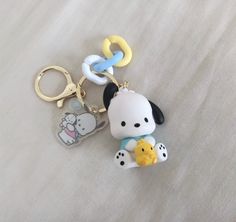 two keychains that are shaped like animals and one has a dog on it