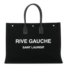 This is an authentic SAINT LAURENT Linen Calfskin Rive Gauche Tote in Black. This stylish tote is crafted of black linen with "Rive Gauche, Saint Laurent" printed in white across the front. The tote features black rolled leather handles and is open toa spacious interior with a hanging zipper pocket. Rive Gauche Saint Laurent, Rive Gauche Bag, Ysl Rive Gauche, Saint Laurent Rive Gauche Tote, Saint Laurent Tote, Rive Gauche, Black Linen, Leather Handle, Zipper Pocket