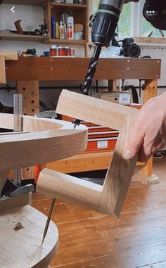 a person using a drill to cut wood