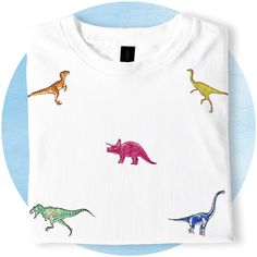 a white t - shirt with colorful dinosaurs on it