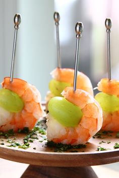 small appetizers with shrimp, celery and olives on a wooden platter