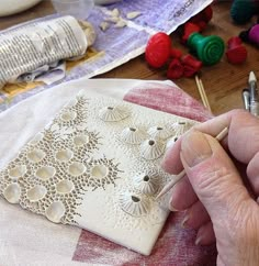 a person is working on an intricately designed piece of art with crochet