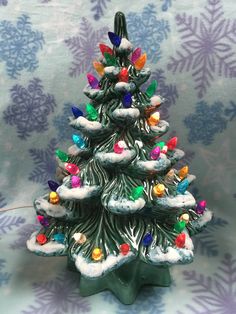 a small christmas tree with colorful lights on it