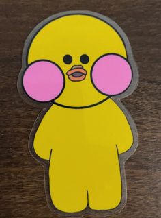 a yellow sticker with pink ears and eyes