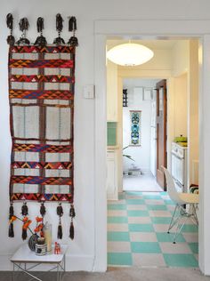 the hallway is decorated with colorful wall hangings