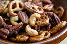 a bowl filled with nuts and pretzels on top of a table