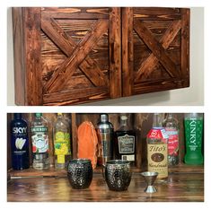 an assortment of liquor bottles and glasses sitting on a wooden shelf next to each other