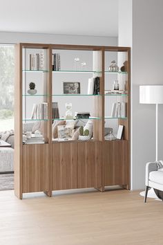 a living room filled with furniture and lots of glass shelves on top of each other