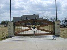 a truck is parked in front of a large gate with a star on the top