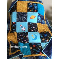 a quilted blanket with space and stars on it