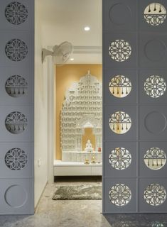 an open door leading to a bathroom with a bathtub in the background and decorative wall panels