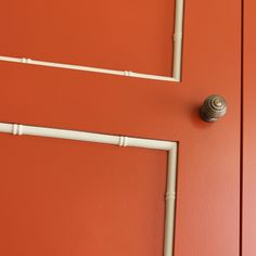 an orange door with white piping on it