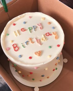 a birthday cake in a box with confetti on it