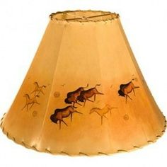 a lamp shade with horses running on the bottom and an old fashioned light fixture in the middle