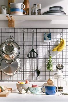 pots and pans are hanging on the wall