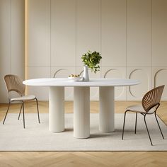 a white table with two chairs next to it and a potted plant on top