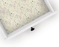 an open white box with floral wallpaper on it