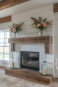 a fireplace with two vases on top of it