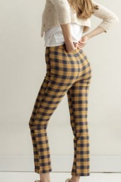 High-waisted pant from Urban Outfitters topped with an allover plaid finish. Notched at the hem and topped with a button closure at the zipper fly. Content + Care - 35% Polyester, 6% rayon, 5% spandex - Machine wash Chic Stretch Plaid Bottoms, Chic Plaid Straight Leg Bottoms, Plaid Tapered Leg Pants For Fall, Stretch Plaid Bottoms For Fall, High Waist Plaid Bottoms For Business Casual, Plaid Tapered Leg Bottoms For Fall, Chic Plaid Bottoms For Business Casual, Chic Fitted Plaid Bottoms, Tapered Leg Plaid Bottoms For Fall