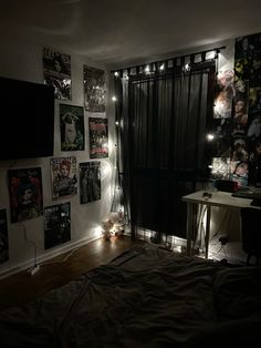 a bed room with a neatly made bed and lots of pictures on the wall