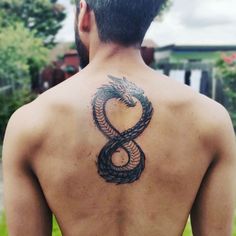 a man with a snake tattoo on his back