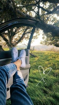 someone's feet sticking out the window of a car