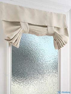 an open window with white curtains in front of it and frosted glass on the outside