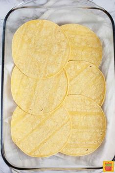 tortillas in a glass dish on a marble counter top