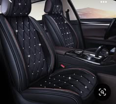 the interior of a car with black leather seats and diamond studded trimmings