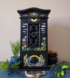 a black clock sitting on top of a blue table