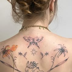 the back of a woman's neck with tattoos on it