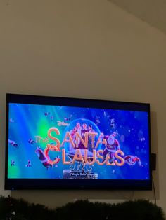 a large television screen with the words santa claus on it