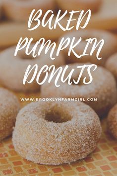 baked pumpkin donuts on a table with the words baked pumpkin donuts above them