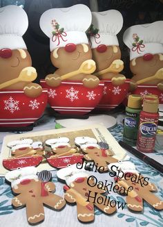 gingerbread cookies in the shape of chefs cooking on top of a table with baking utensils