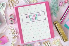 a pink binder surrounded by office supplies on a white surface with the words life planning binder